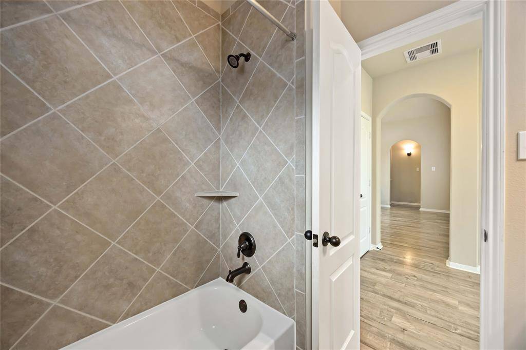 A view from the bathroom that  provides a clear view of the home's design flow,