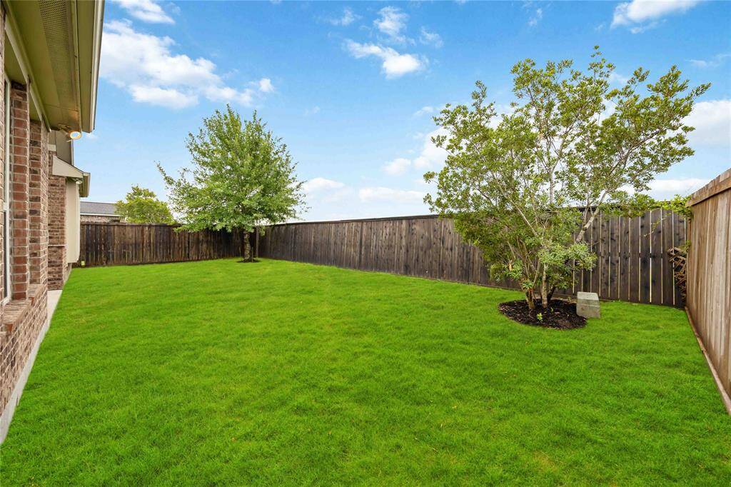 Enjoy this fully fenced backyard with beautifully maintained lush green lawn ,perfect for outdoor activities or relaxing in your private outdoor haven.