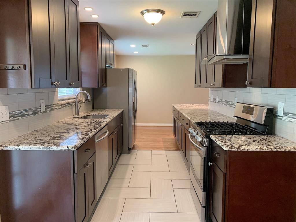 Stunning Completely remodeled kitchen with granite countertops, decorative tile backsplash & tons of cabinet space!
