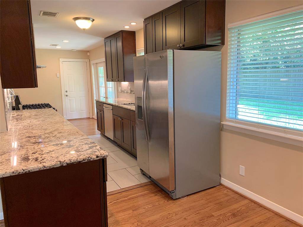 Stunning granite countertops. Recessed lights. Kitchen has view of back yard.