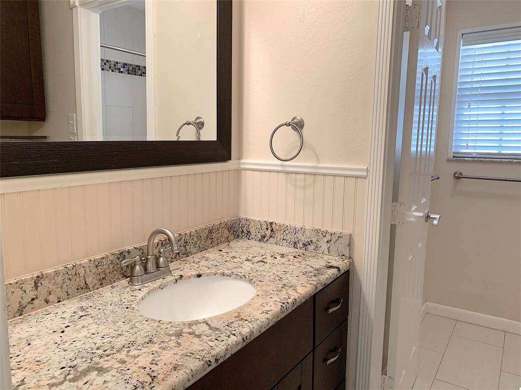 Totally remodeled guest bathroom with granite countertops and undermount sink.  Beadboard trim. Brushed nickel fixtures and faucets hardware.