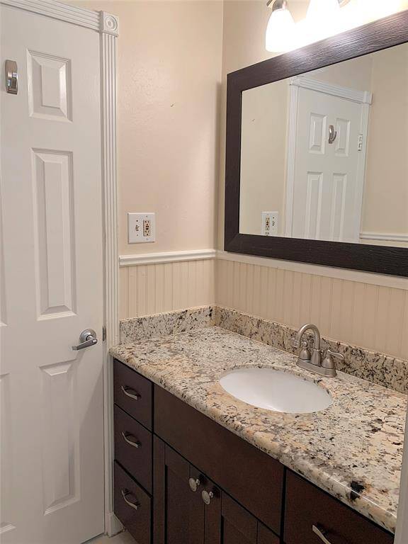 Guest bathroom has lots of storage space in vanity area.