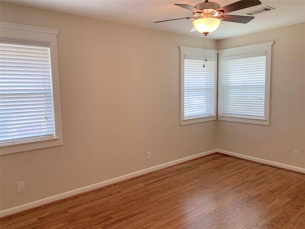 View of guest bedroom with lots of double-paned windows.