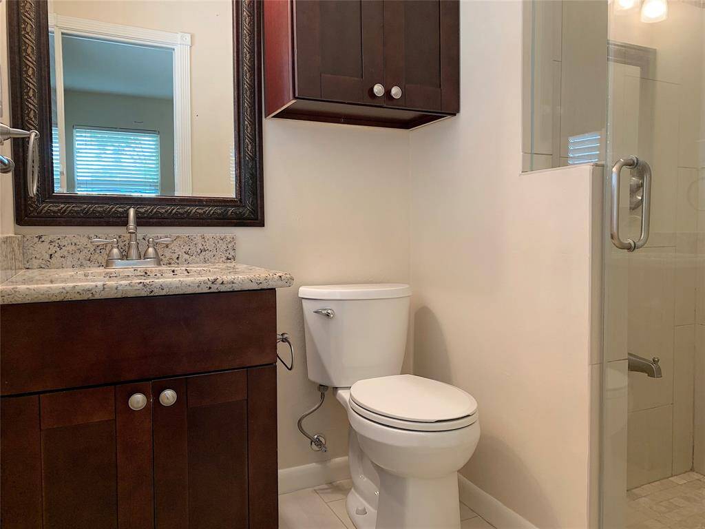 View of completely remodeled Primary bathroom with granite countertop!