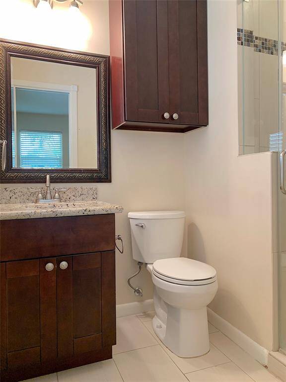 Primary bathroom has vanity storage and extra linen cabinet located above the toilet.