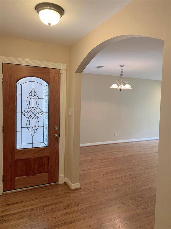 Inviting front entry. Graceful arch leading to dining area.