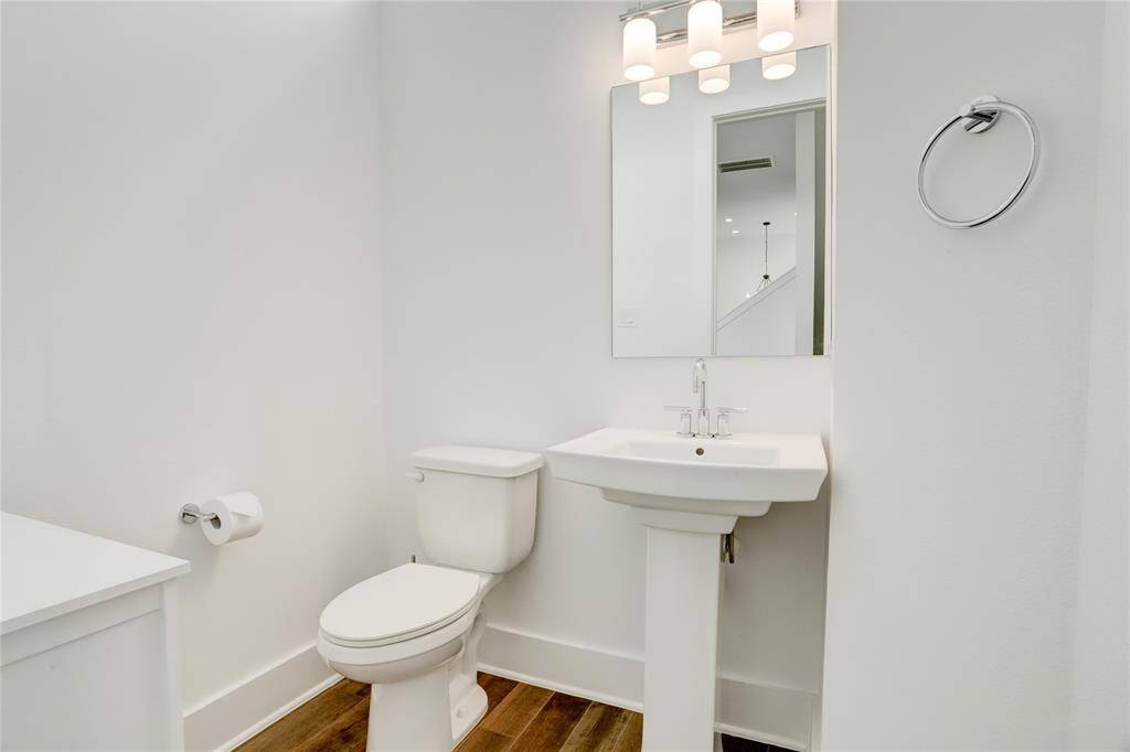 The half-bath just off the main living area. The door is just to the right as you ascend the stairs from the foyer.