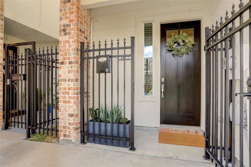 The gated front entrance to Unit B, complete with a mailbox and space for planters. Just out of frame is a grass strip running alongside the home (all gated) which makes for a perfect dog run.
