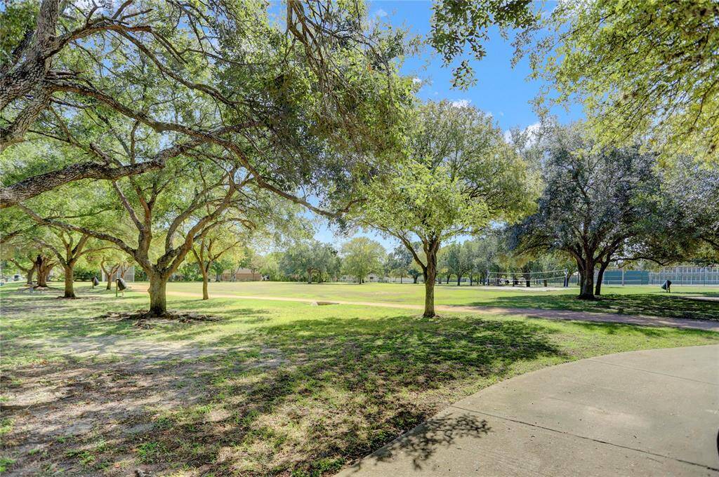 Shady Oak trees with 1/4 mile walking trail and park benches.