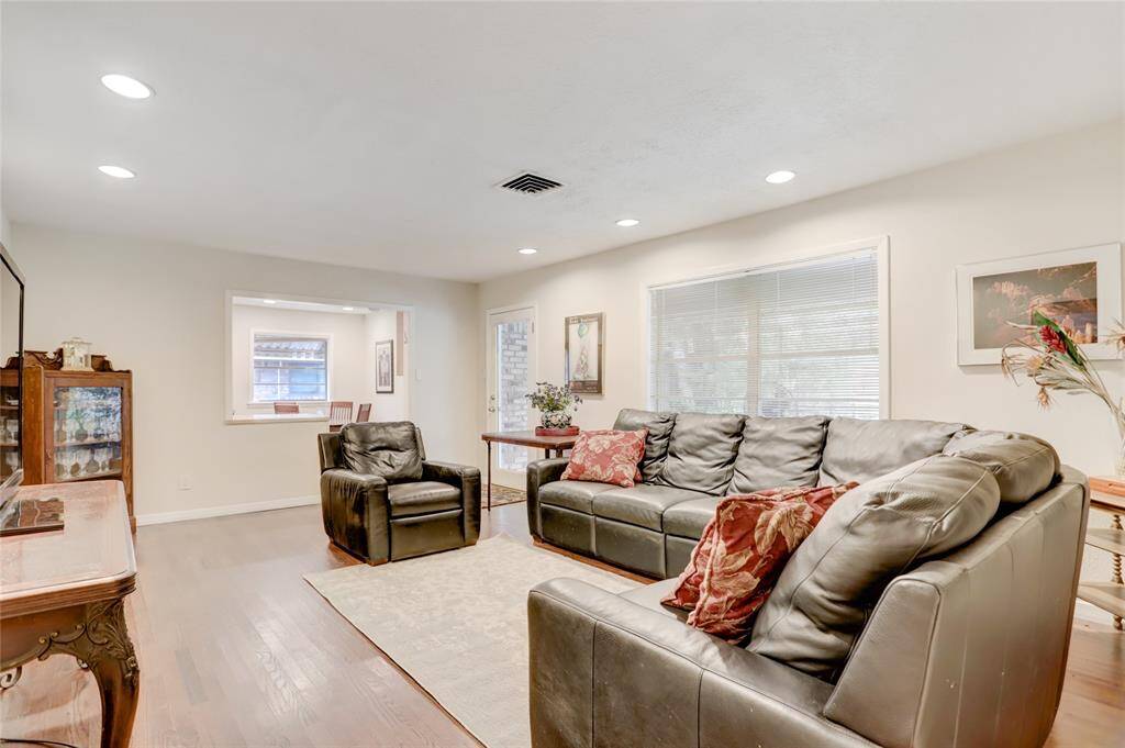 Another view of the den showing large window, French door to the back patio and pass through to the kitchen breakfast.