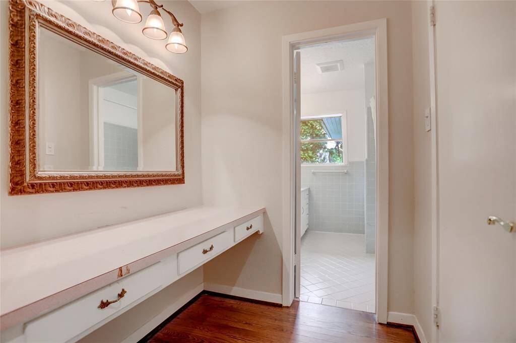 Sit down vanity area, and linen closet as you approach the hall bath.