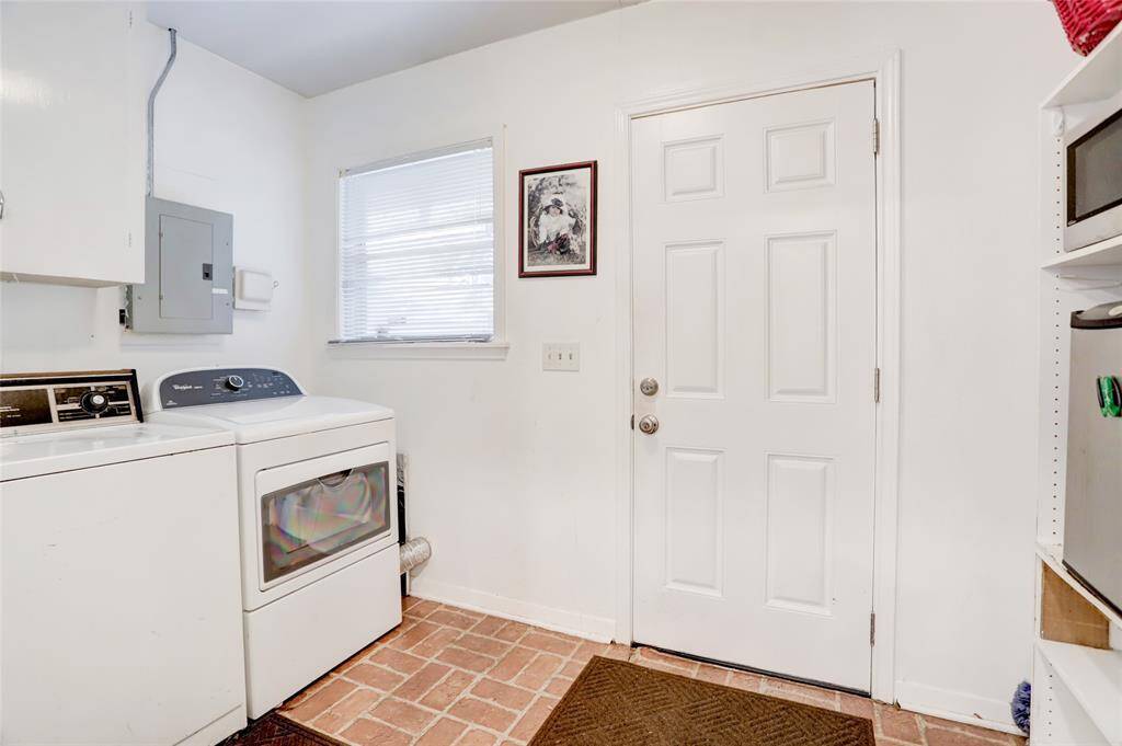 Utility room just off the breakfast room offers entry from the Detached garage.  Note the water heater, electrical panel, and electric only outlet for dryer.