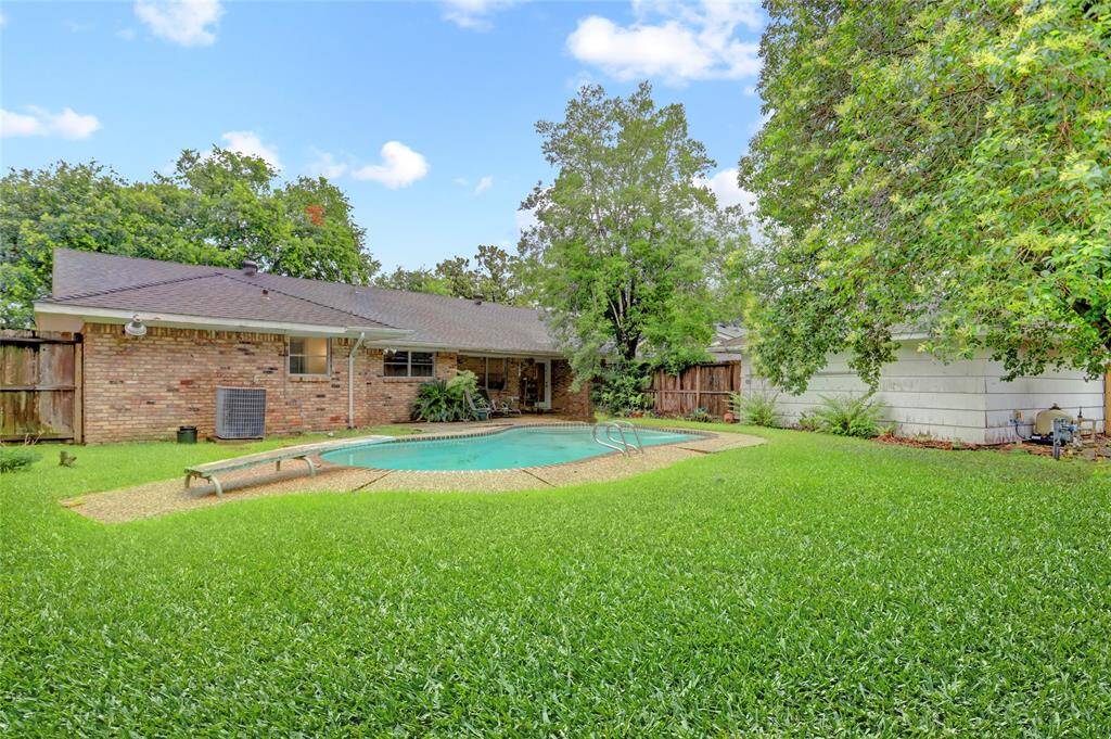 Another view of the spacious backyard Showing generous amount of turf for recreation and the two car detached garage. Note….the turf is virtually enhanced.