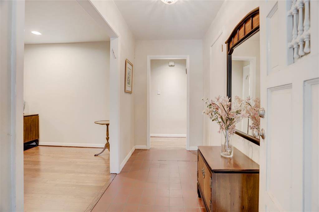 Tiled entry looking into original formal living room and access to the bedroom hall and family room. Note guest closet on the right.