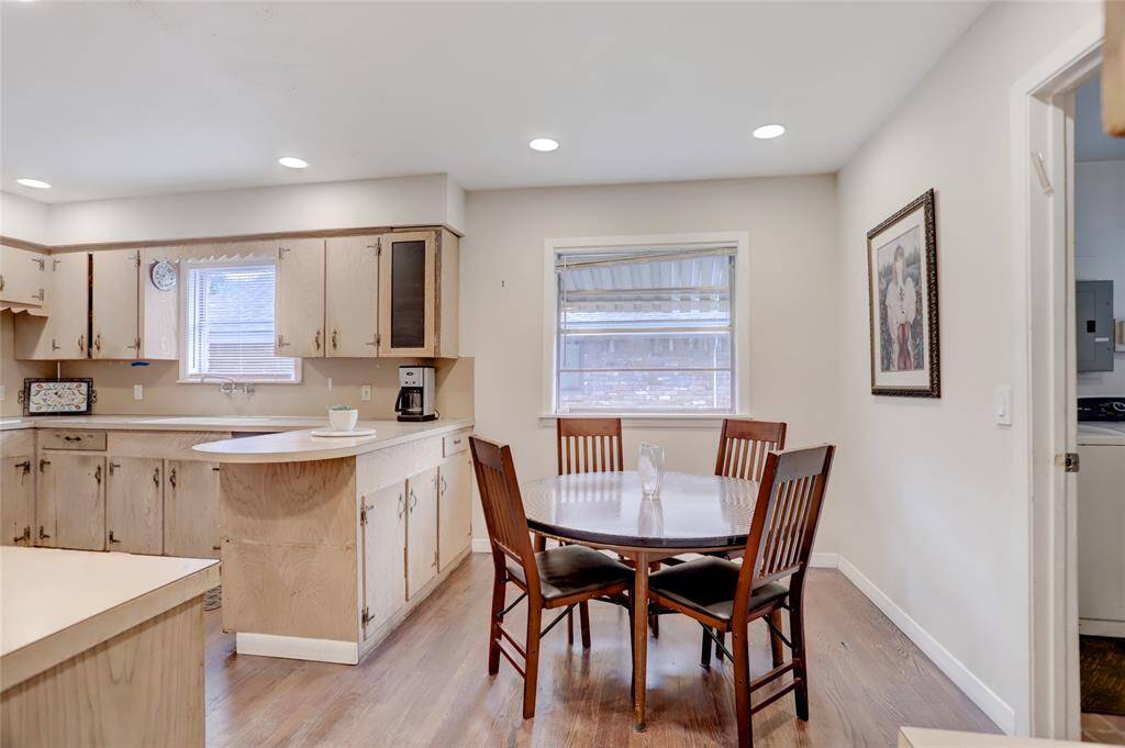 Breakfast room with large window overlooking driveway and access to both kitchen and utility room
