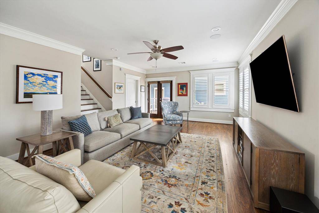 Tucked at the back of the home, this comfortable family room offers a quiet retreat with ample natural light and views of the backyard. Crown molding, recessed lighting, and rich hardwood floors create a warm and polished feel. It's an ideal space for relaxing, gathering, or enjoying movie nights at home.