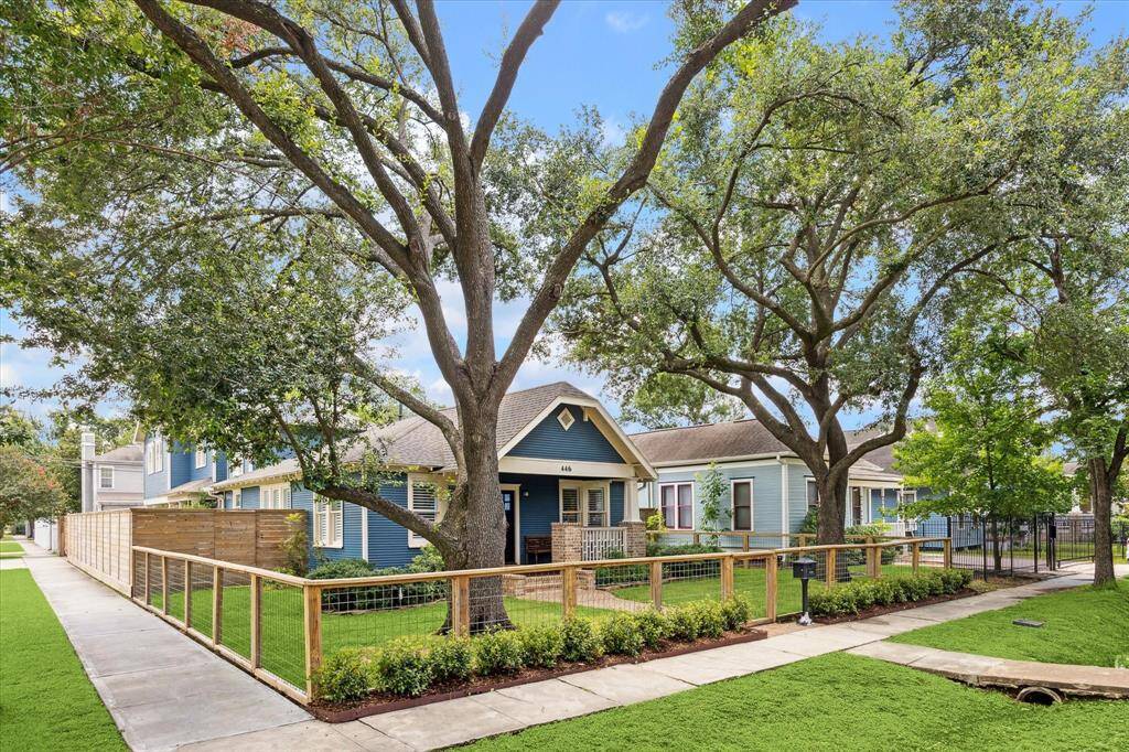 Ideally positioned on a spacious corner lot, the home is fully fenced, offering both privacy and charm. The wraparound fence enhances the curb appeal while creating a secure and inviting outdoor space shaded by mature trees. With sidewalks on both sides, the property feels open yet protected—perfect for enjoying the vibrant neighborhood atmosphere.