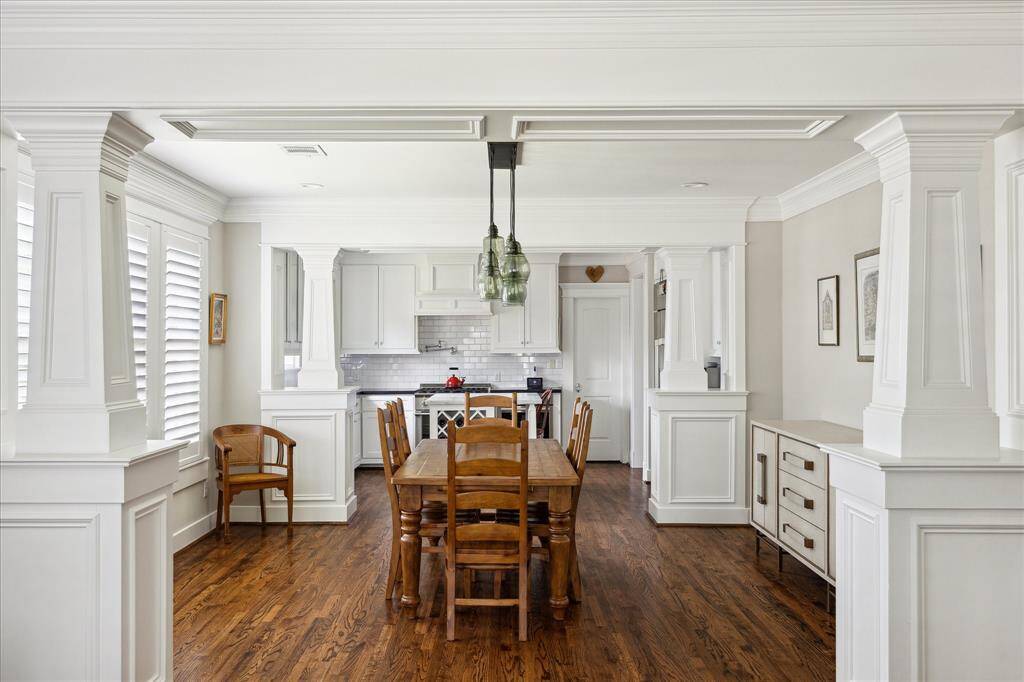 Framed by substantial millwork and detailed columns, the formal dining room offers timeless elegance and architectural charm. Wide cased openings create seamless flow from the formal living into the kitchen.