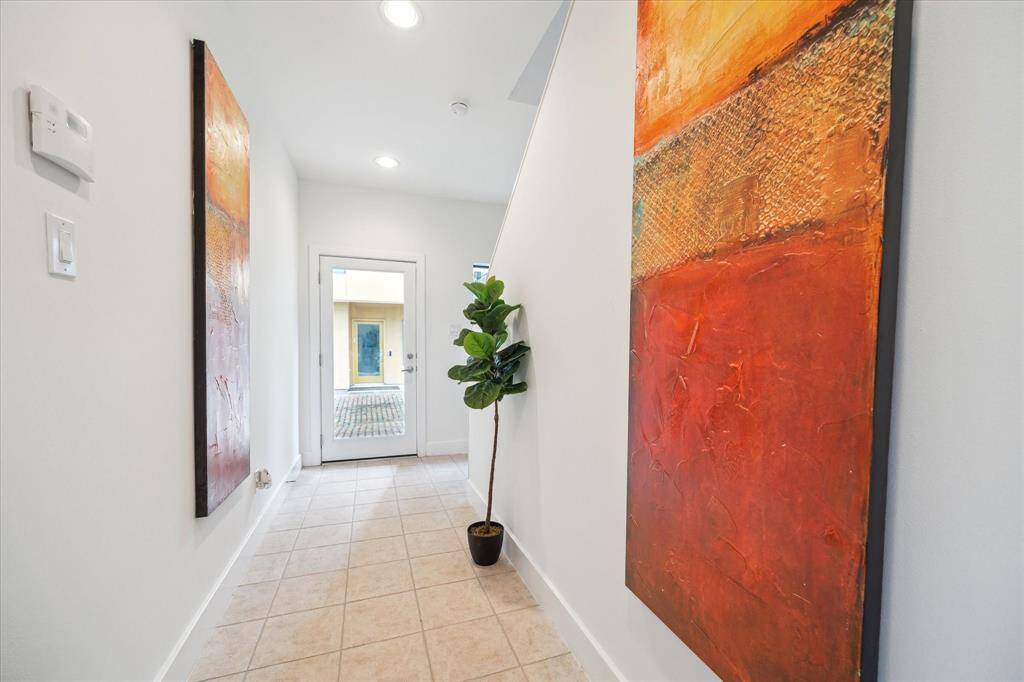 The primary bedroom features a modern design with a spacious layout.  There is sitting area and a large walk-in closet.
