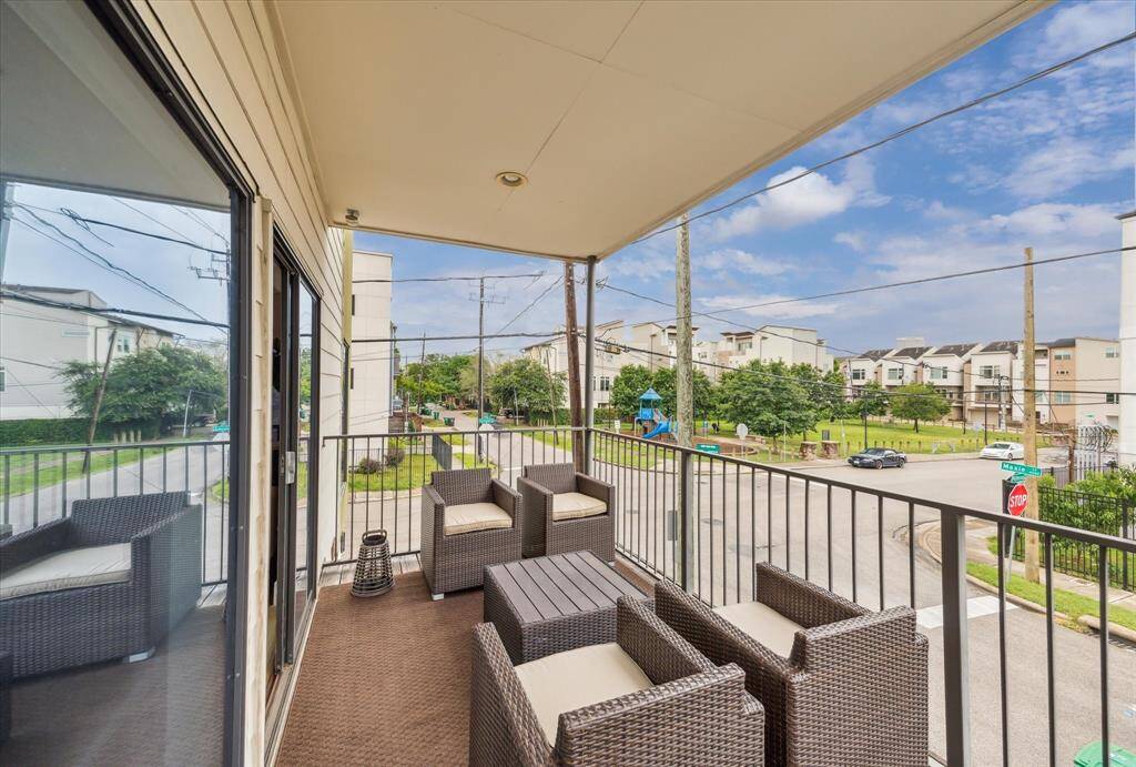 Spacious balcony with comfortable outdoor seating, overlooking the West End park and playground.  Ideal for relaxing and enjoying the view.