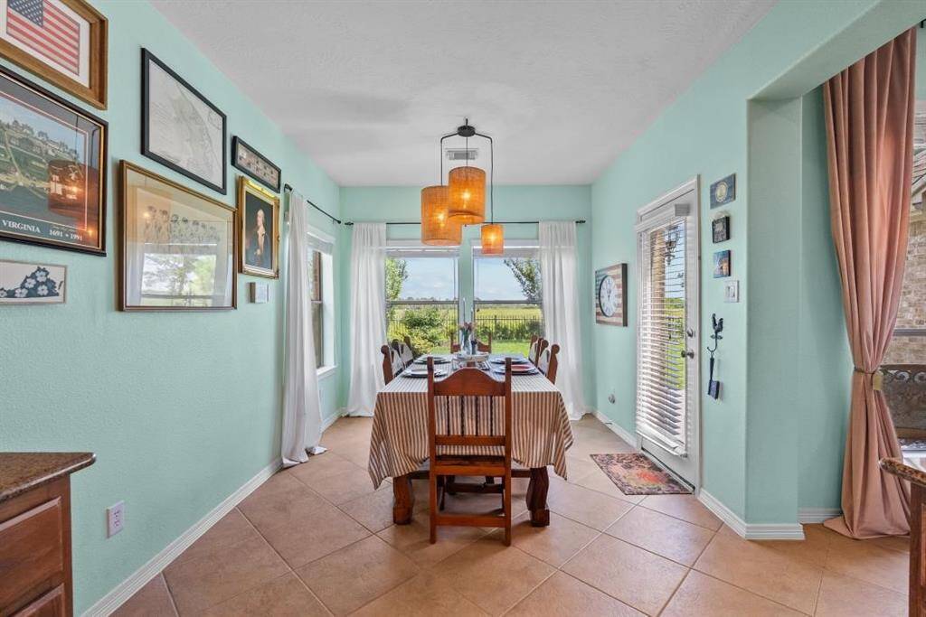 Enjoy the views of the backyard from the breakfast area with entrance to the patio.