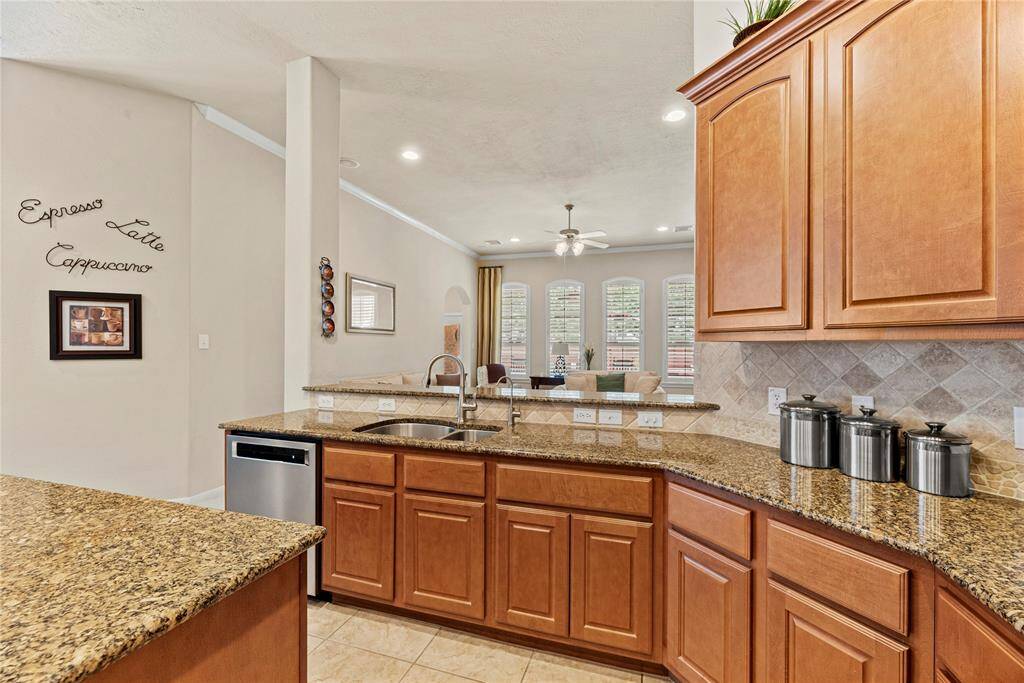 Granite countertops paired with a coordinating stone backsplash not only provide a durable and elegant surface for food preparation but also add a touch of luxury and sophistication to the kitchen.