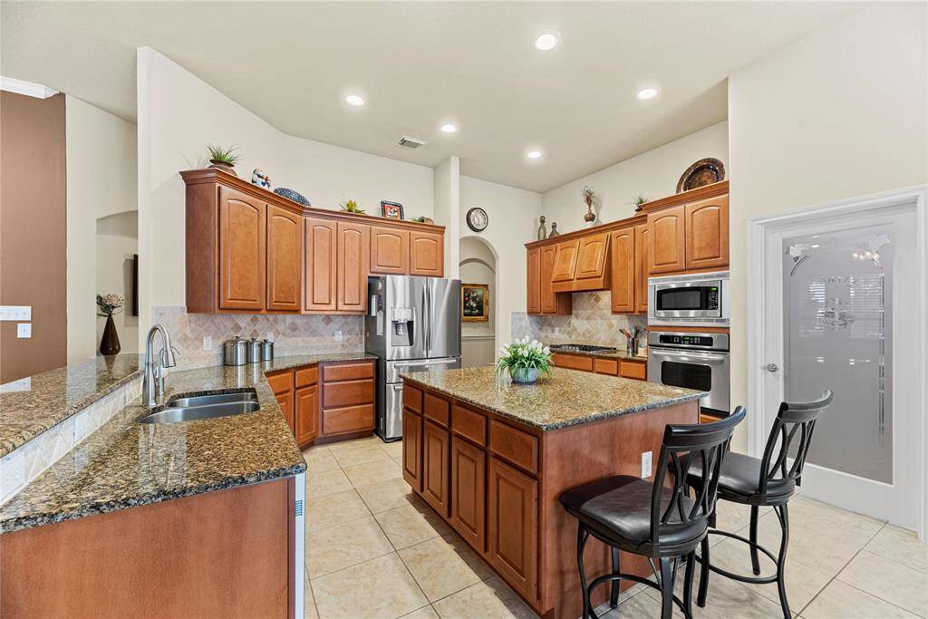 Rich cabinetry offers a clean, timeless aesthetic that elevates the space with a sense of brightness and openness.