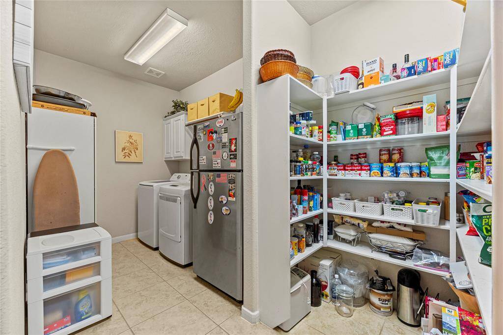 A spacious walk-in pantry provides ample storage for all your kitchen essentials, while the uniquely designed laundry room offers both functionality and charm—making everyday living easier and more enjoyable for busy families.