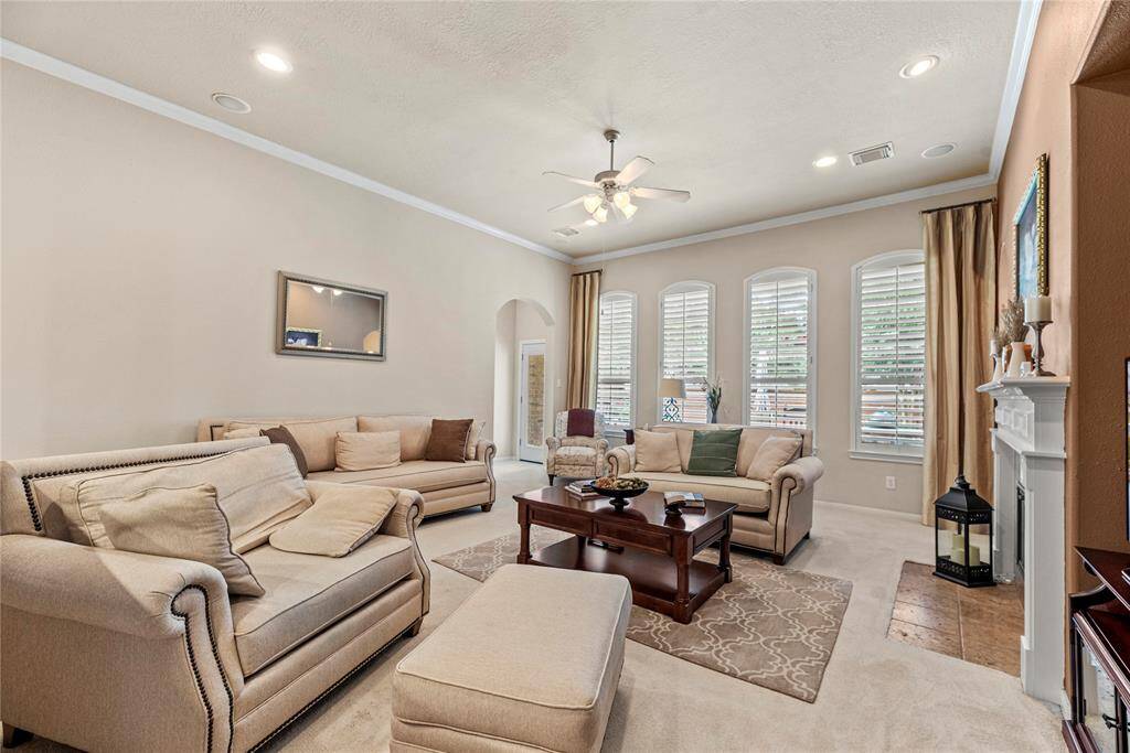 Welcome to a chic and airy living space, where a wall of windows lets the sunshine pour in, creating a bright, cheerful atmosphere that's perfect for both relaxing days and lively gatherings.