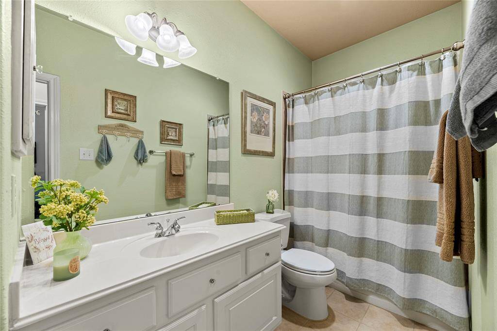 The secondary bathroom is thoughtfully designed to meet the needs of busy families with a large vanity and tub/shower combo.