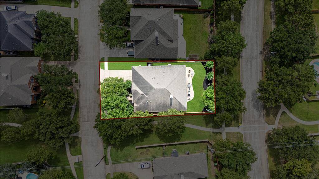 This stunning aerial view beautifully showcases the spacious patio and lush green backyard, perfect for outdoor entertaining and relaxation.