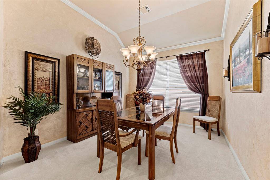 The formal dining room offers generous space to comfortably accommodate a dining table, buffet, and china cabinet—an ideal setting for hosting elegant dinners and memorable gatherings.