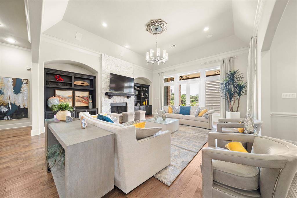 Beautiful Stone Fireplace with Huge windows overlooking the Gorgeous Backyard!