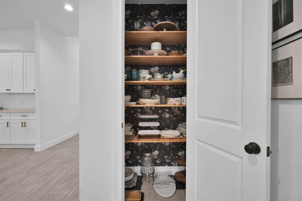 Custom built-in selves and cabinets with two desks and lighting.