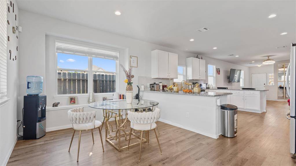 Full view of dining area and kitchen tons of natural light!