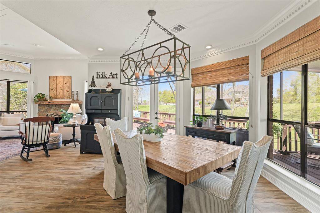 A pair of glass-plated French doors provides direct access to the large Deck and adjoining screened-in Porch beyond, providing a great place to enjoy an al fresco lunch.