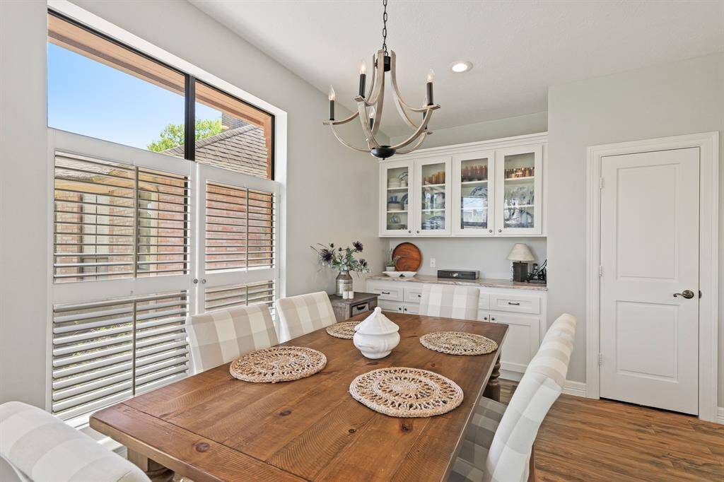 The Breakfast Room can easily accommodate a 6–8-person table comfortably, with room to spare. Notice how the wood and iron chandelier coordinate with the fixtures seen previously in the Living Room and Foyer.