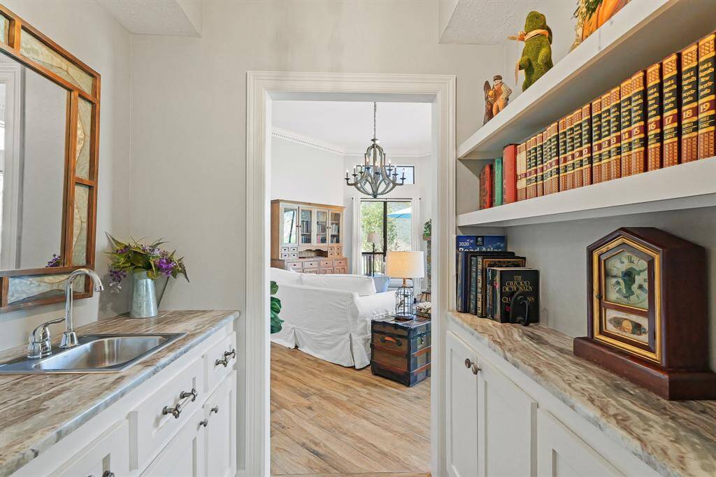 This Wet Bar is easily accessible from the Living Room, Dining Room, and Kitchen. With an abundance of open and closed storage, this is the ideal place to store your favorite drinks and glassware when entertaining guests.