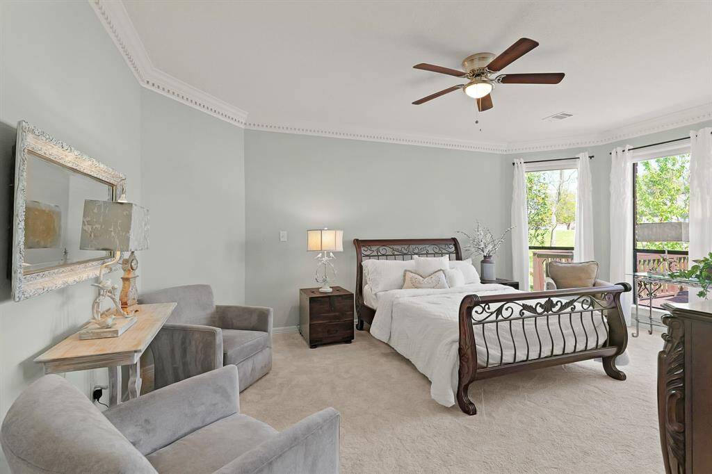 Relax and unwind at the end of a long day in the comfort of this spacious Primary Retreat. Equipped with crown molding, plush carpeting, and a calming blue hue, this space is sure to suit your needs.