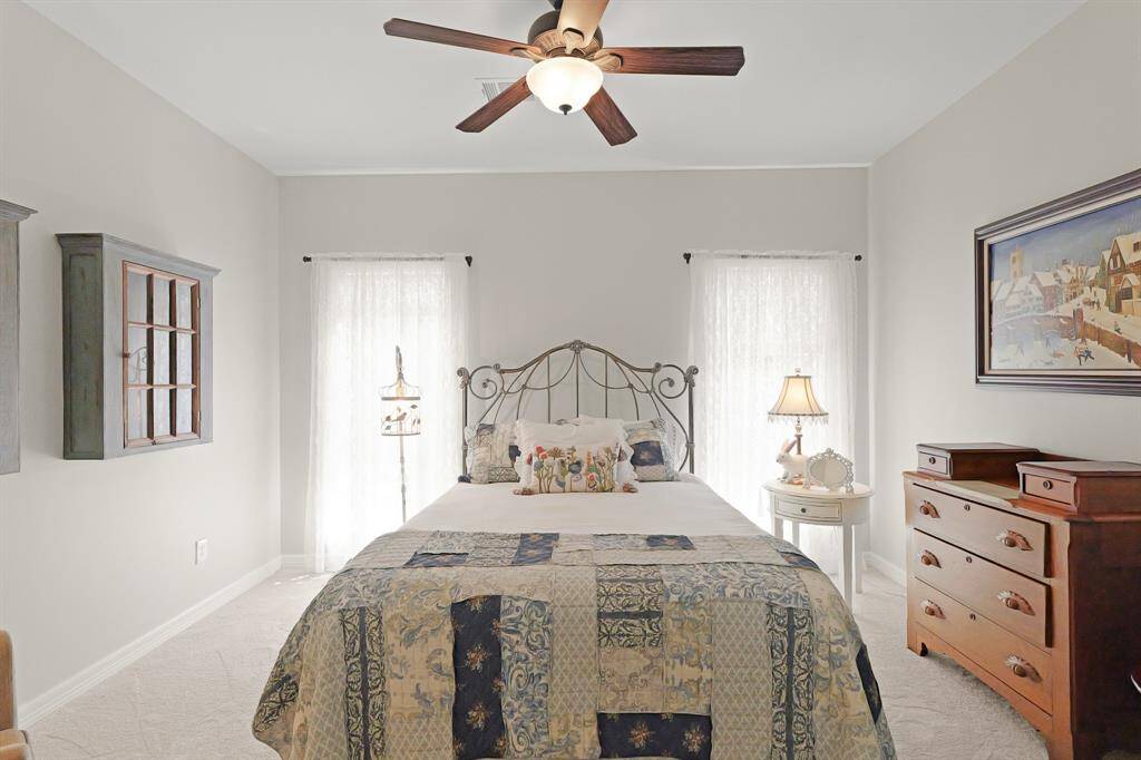 The Secondary Bedrooms boast all the same features, only this one has two windows that overlook the Side Yard. The shared Bathroom is conveniently located directly across the hall.