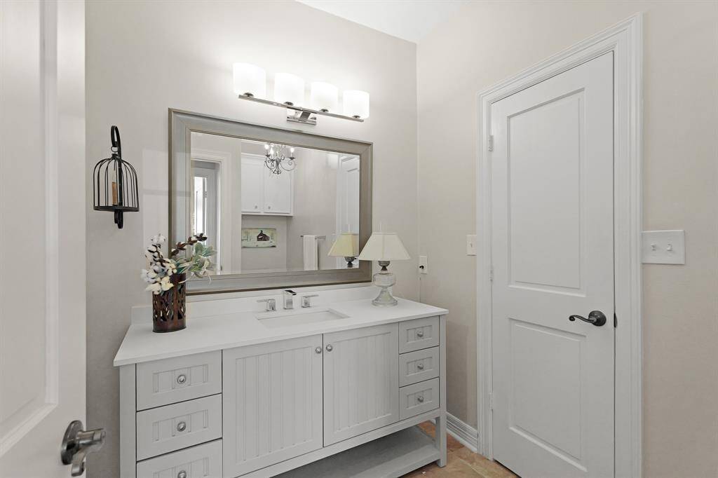Both Secondary Bedrooms share this spacious Bathroom. The space comes equipped with an oversized vanity, quartz countertop, undermount sink, custom framed mirror, and walk-in shower.
