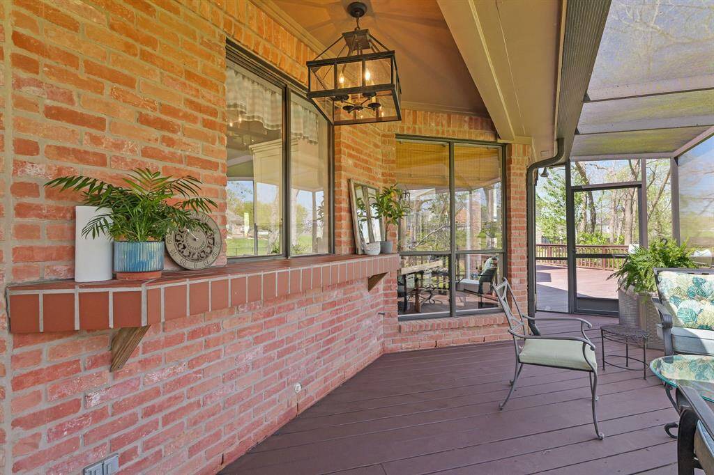 Unique to this screened-in Porch is this brick counter, ideal for displaying an array of yummy treats. The window above leads directly into the Kitchen making it easy for the home chef to share freshly baked goodies with friends and family enjoying the outdoors.