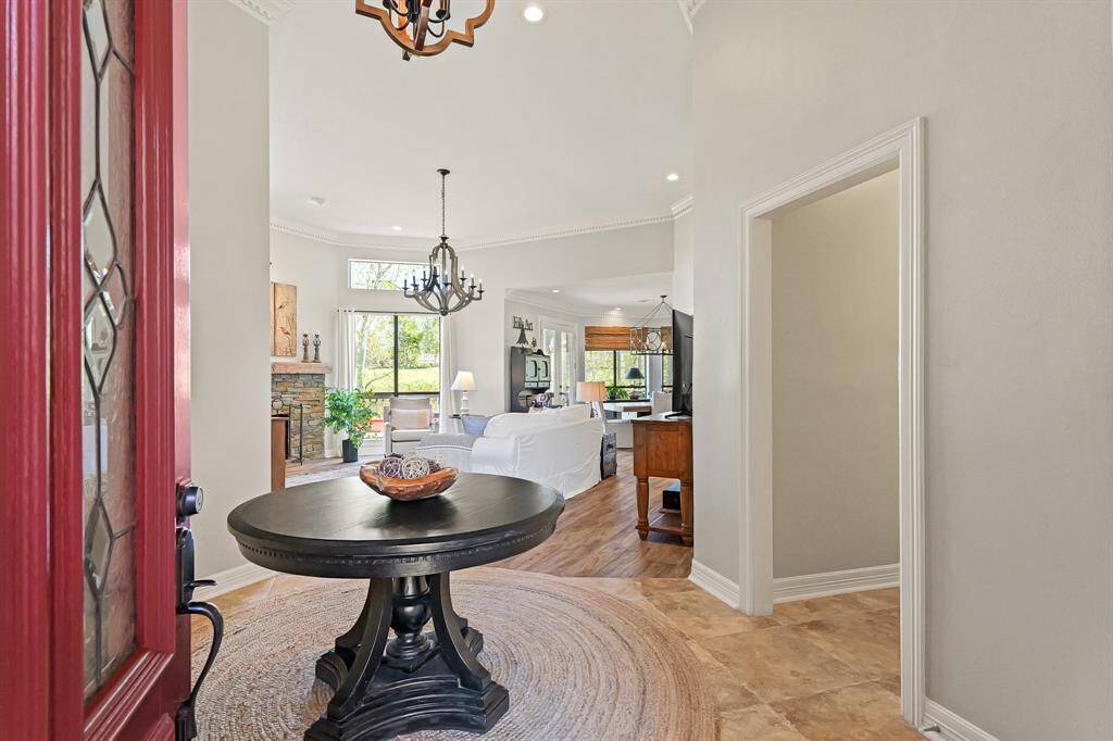 The spacious entryway provides a jaw dropping first impression. Eyes are immediately drawn towards the lush green scenery found beyond the back windows and wind around towards the Dining Room and Kitchen.