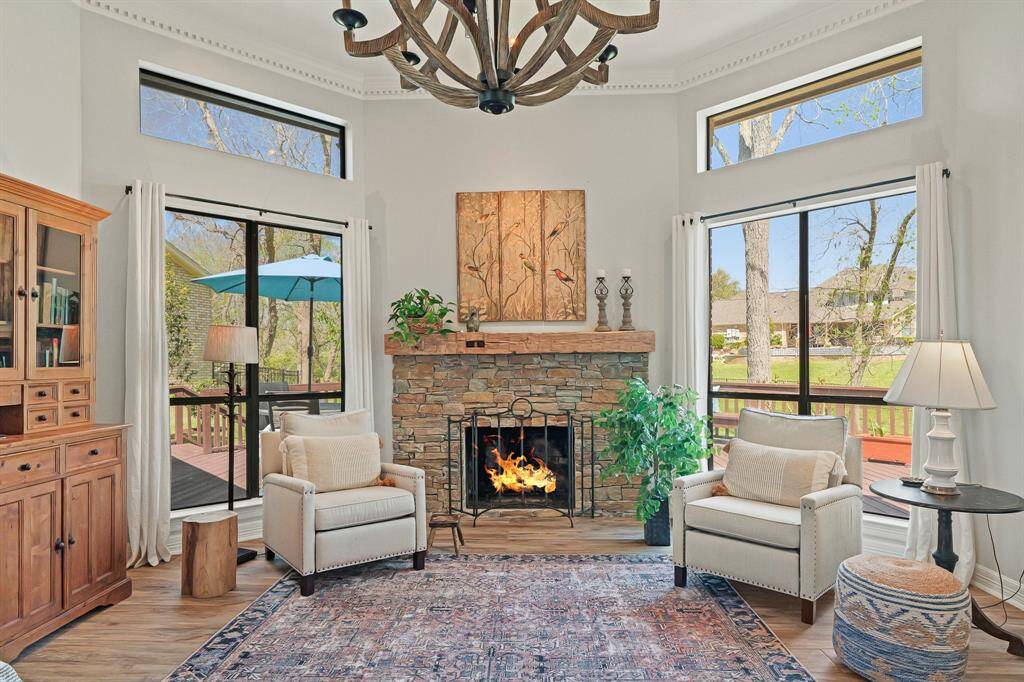 This stacked stone, gas fireplace with custom wood mantle anchors the space, emoting an abundance of old-world charm. Recessed lighting shines brightly atop the mantle, providing a great place to display art or a TV.