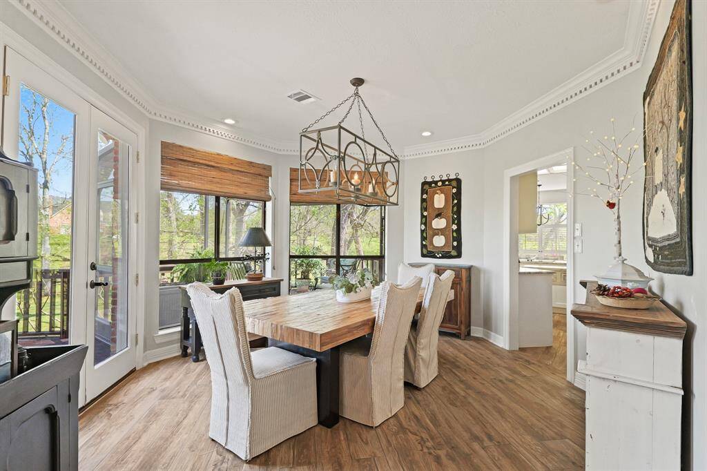 This spacious Dining Room is conveniently located between the Living Room and Kitchen. The room includes crown molding, recessed lighting, and an intricate, wrought iron chandelier. The room is grand in size and can easily accommodate additional furniture like a buffet or drink cart.
