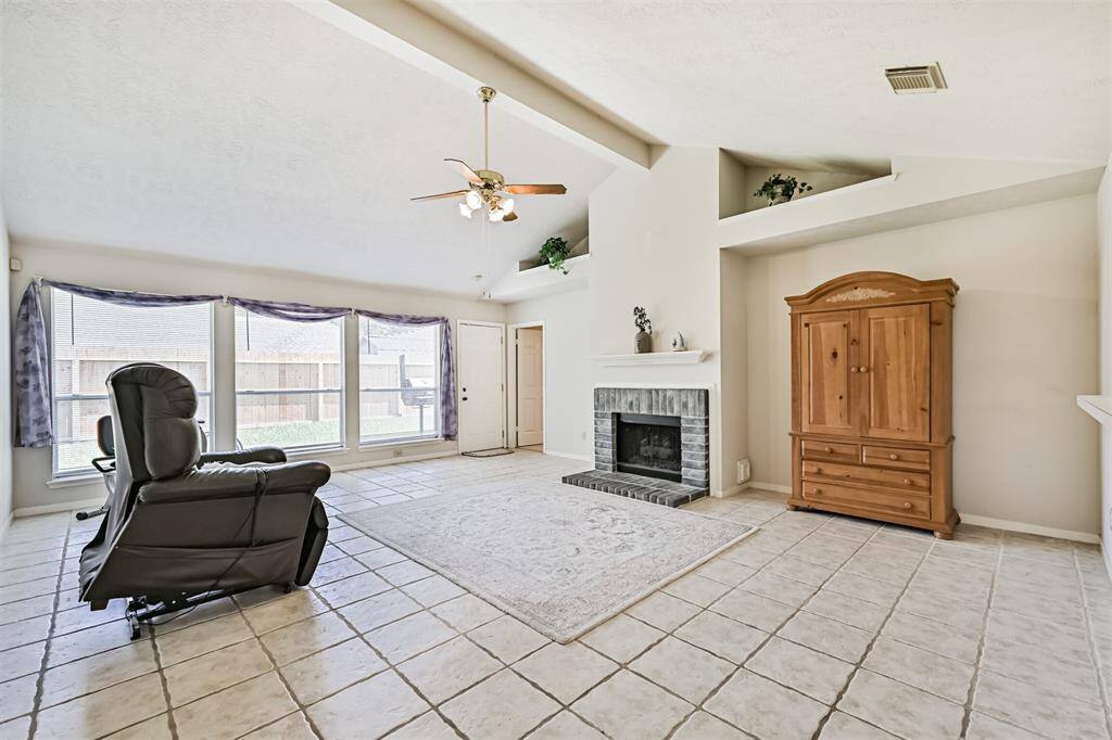 Large living area with high ceilings & natural lighting