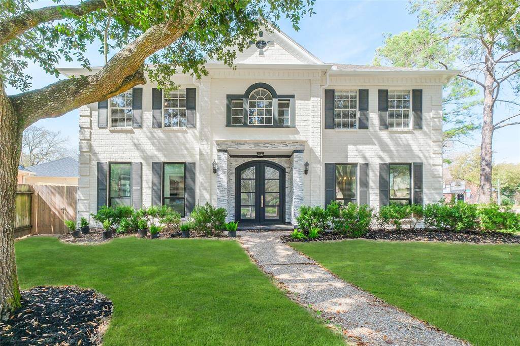 Experience luxury redefined in this impeccably reimagined executive home by Scorpio Development. This sophisticated home has been meticulously renovated from the studs; its original brick modernized with a classic off white and black color scheme accented with a stacked stone and slate entry and a beautiful iron and glass front door.