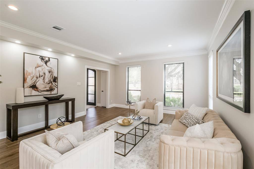 Alternate view of formal living showcasing the art lighting and window treatments. (previously staged)