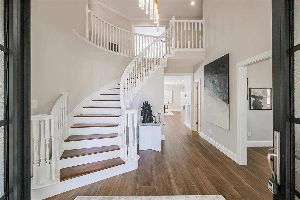 The two story entry way is nothing short of spectacular with its curved wooden stairway and stunning 12’ modern chandelier that sets the tone for this beautiful home. Balulsters are now wrought iron; photos coming soon