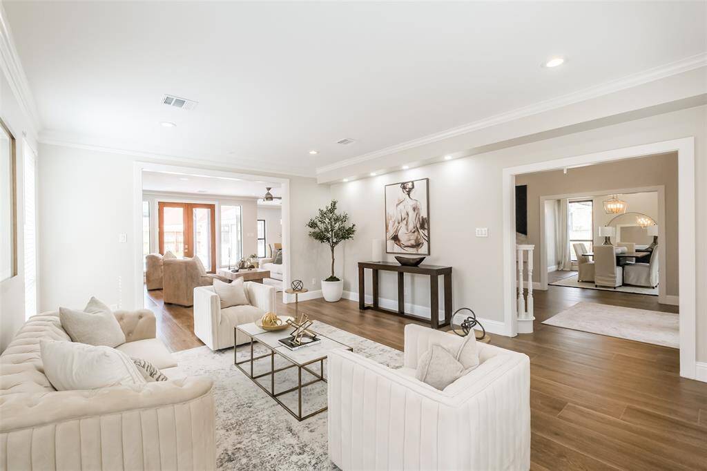 The formal living room features wood look tile flooring, crown molding, window treatments and LED lighting designed to showcase your artwork. Look at this great floorplan! (previously staged)